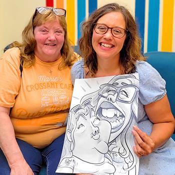 A couple happily displaying their drawing