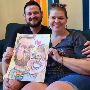 A couple happily displaying their drawing