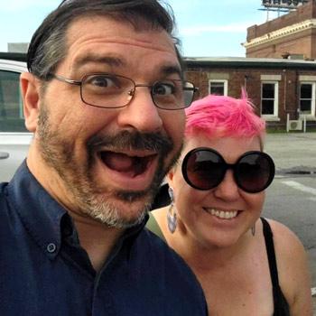 Two poeple smiling in front of the Chattanooga Choo Choo building